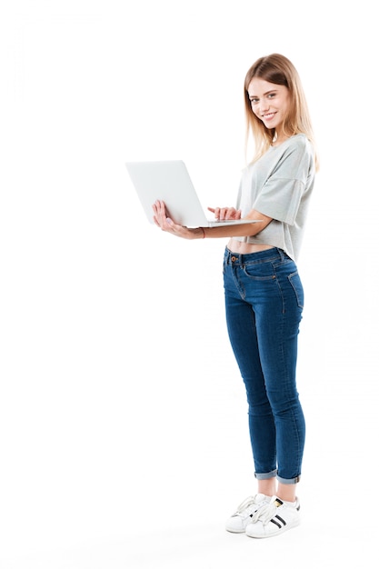 Full-length shot of woman using laptop computer