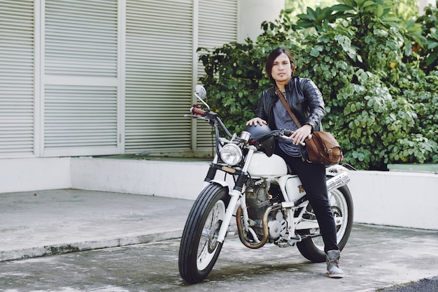 Full-length view of biker ready to ride his motorcycle