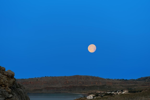 Free Photo full moon moon in the early morning before sunrise rhodes island magnificent scenery in the greek islands of the dodecanese archipelago a famous vacation and travel destination