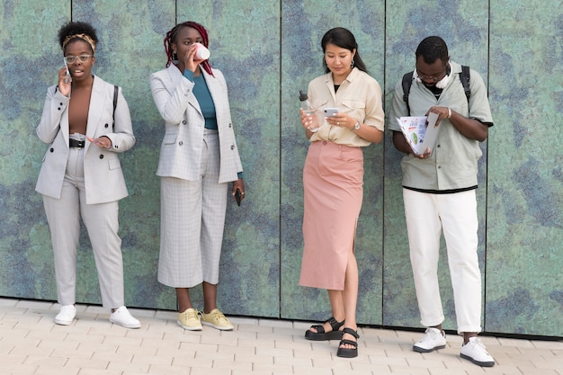 Full shot adults standing outdoors