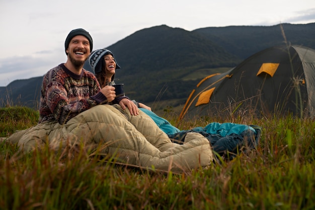 Free Photo full shot adventurous couple bivouacking