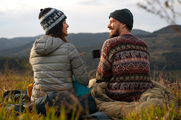 Full shot adventurous couple bivouacking