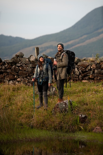 Full shot adventurous couple bivouacking