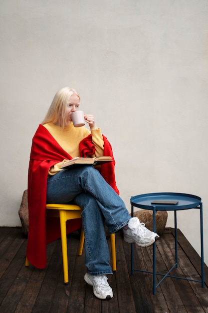 Free Photo full shot albino woman reading