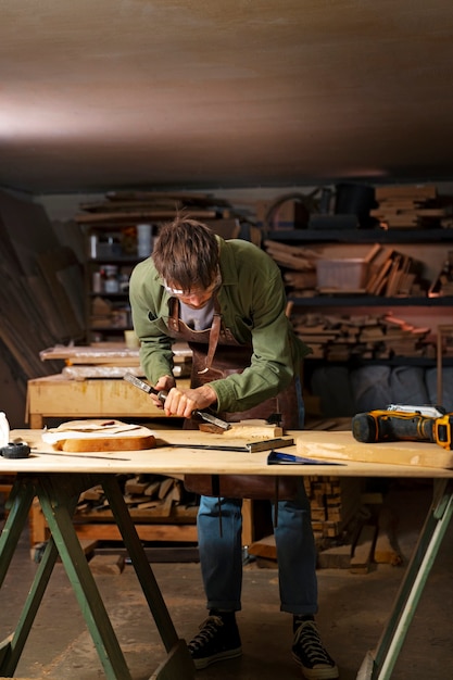 Free Photo full shot artisan doing woodcutting