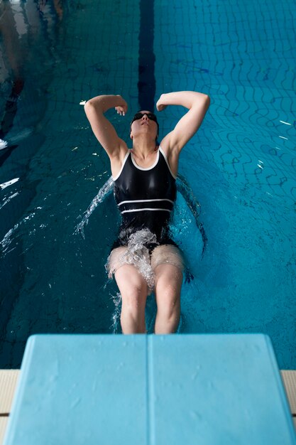 Full shot athlete swimming in pool