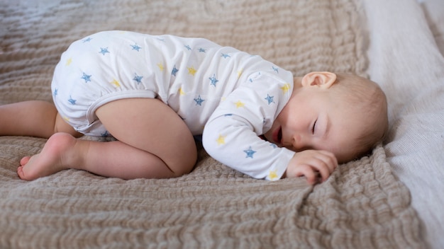 Full shot baby sleeping on blanket