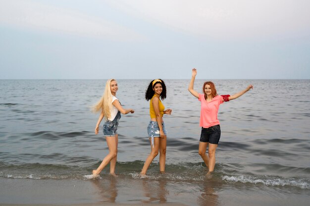 Full shot of beautiful friends at beach