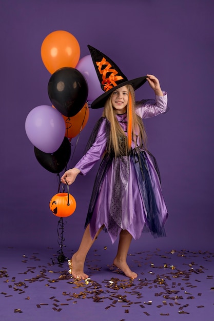 Free photo full shot of beautiful girl with witch costume