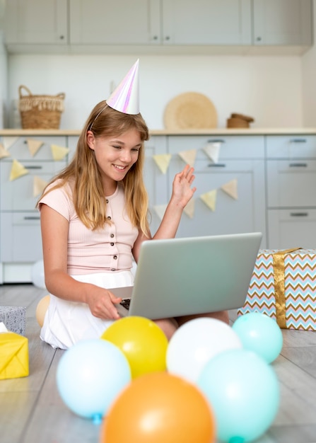 Full shot birthday  girl holding laptop