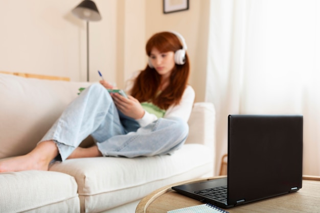 Full shot blurry girl with headphones