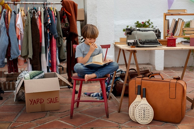 Free Photo full shot boy at garage sale