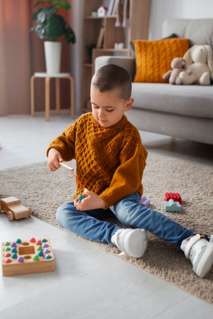 Full shot boy playing at home