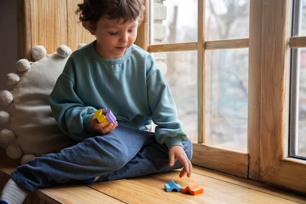 Full shot boy playing memory game