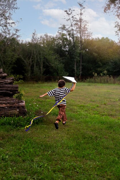 Full shot boy playing in nature