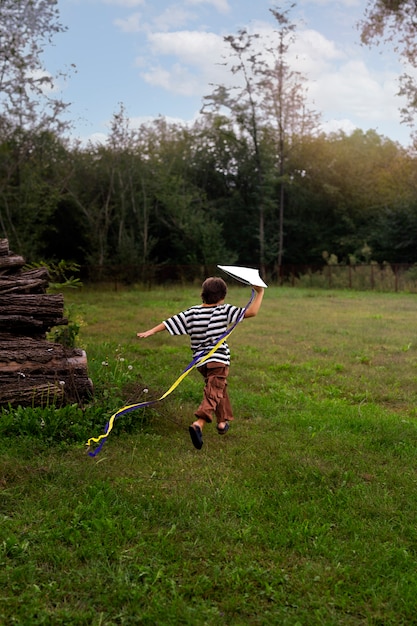 Full shot boy playing in nature