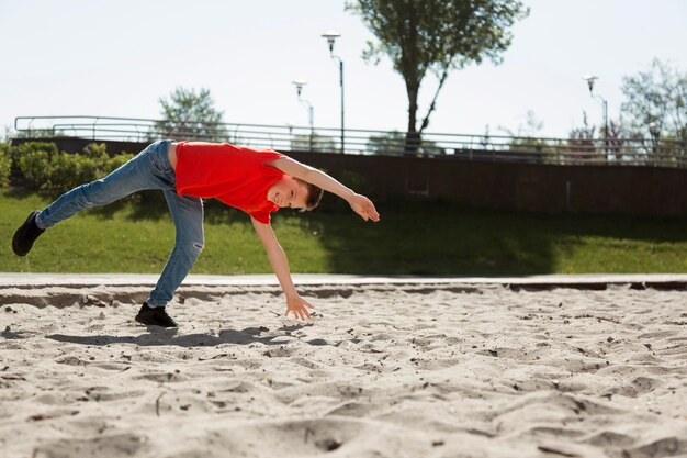 Full shot boy tumbling