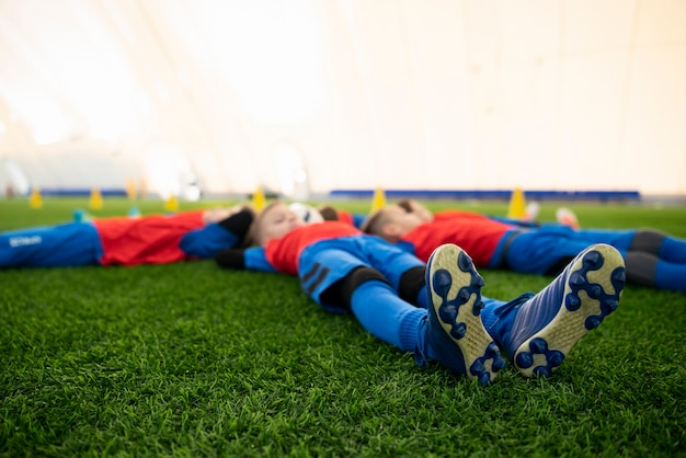 Free photo full shot children laying on grass