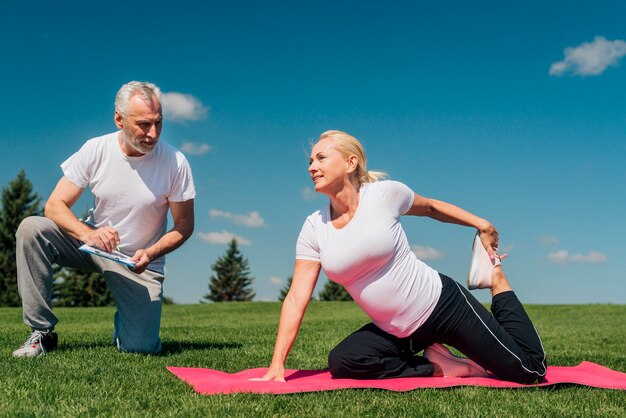 Full shot coach training woman in nature