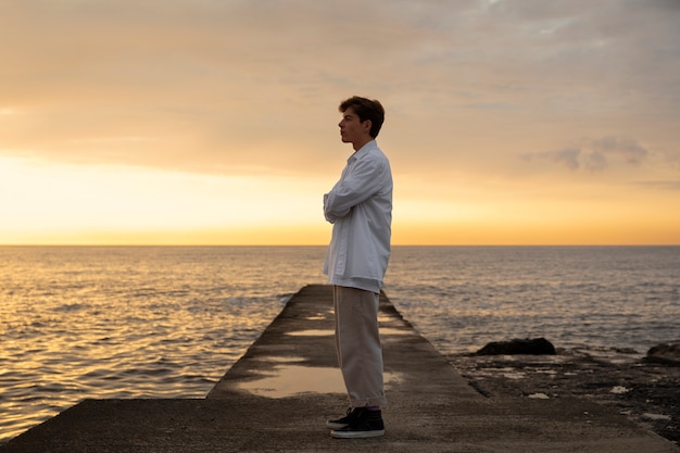 Full shot contemplative man at the seaside