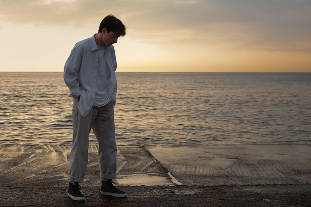 Full shot contemplative man at the seaside