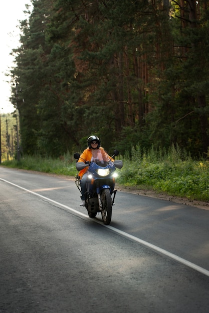 Free photo full shot cool old woman with motorbike