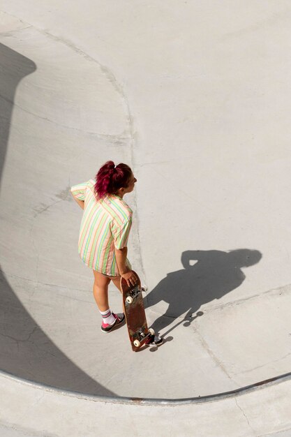 Full shot cool woman on skateboard