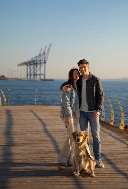 Free photo full shot couple hanging out on a jetty