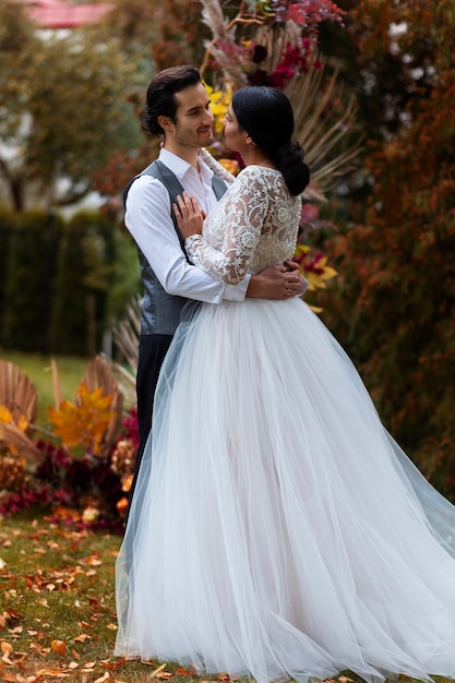 Full shot couple posing at wedding