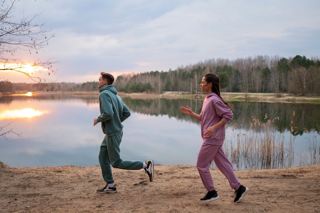 Free photo full shot couple running together