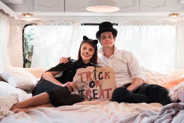 Full shot couple sitting in bed