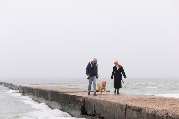 Full shot couple spending time at seaside