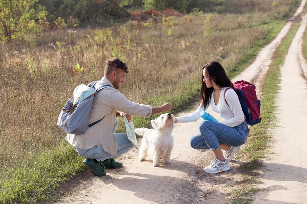 Full shot couple traveling with dog