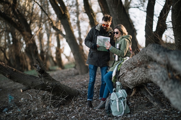 Full shot couple with map outdoors