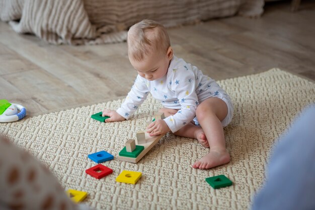 Full shot cute baby playing on floor