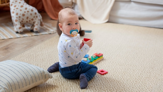 Full shot cute baby with pacifier