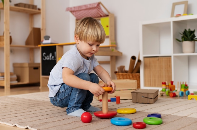 Full shot cute kid playing with wooden toy