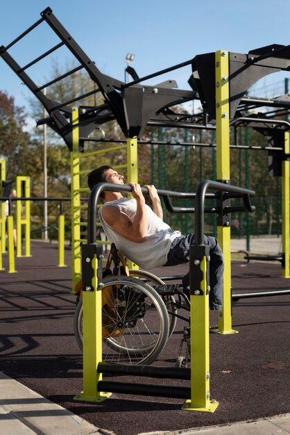 Full shot disabled man doing sport in park