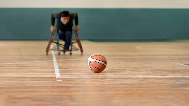 Full shot disabled man going after basketball