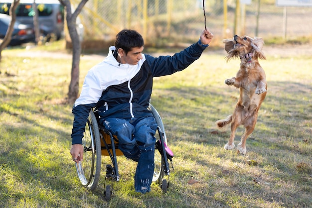 Free Photo full shot disabled man playing with dog