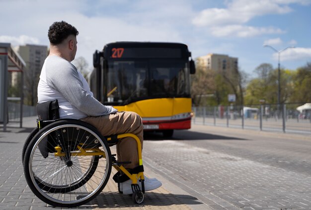 Full shot disabled man waiting for the bus