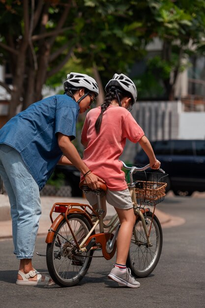 Full shot family cycling outdoors