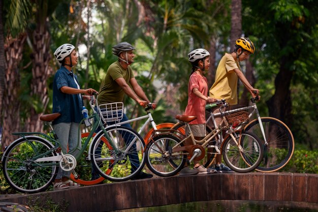 Full shot family cycling outdoors