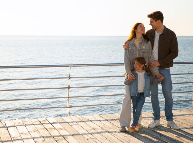 Free Photo full shot family hanging out on a jetty