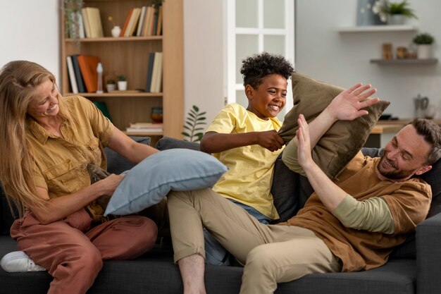 Full shot family members playing together