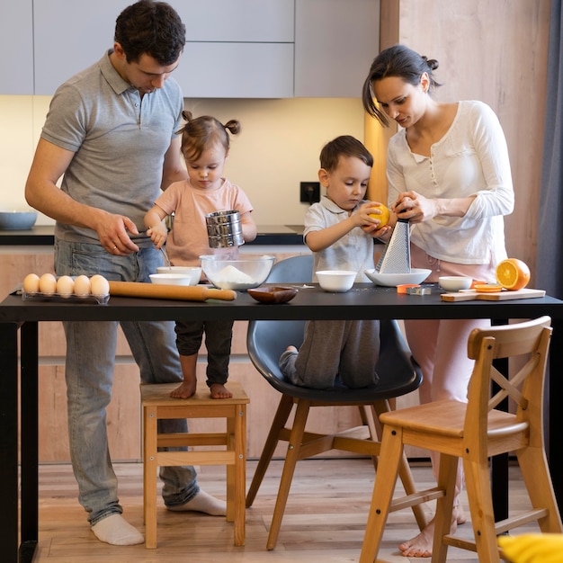 Full shot family preparing food