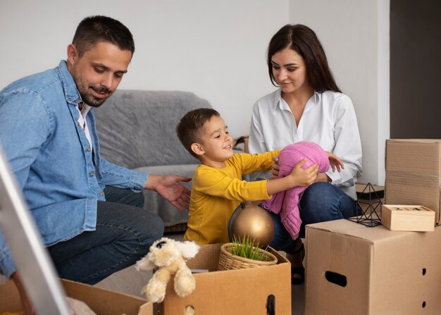 Full shot family ready to move into a new home