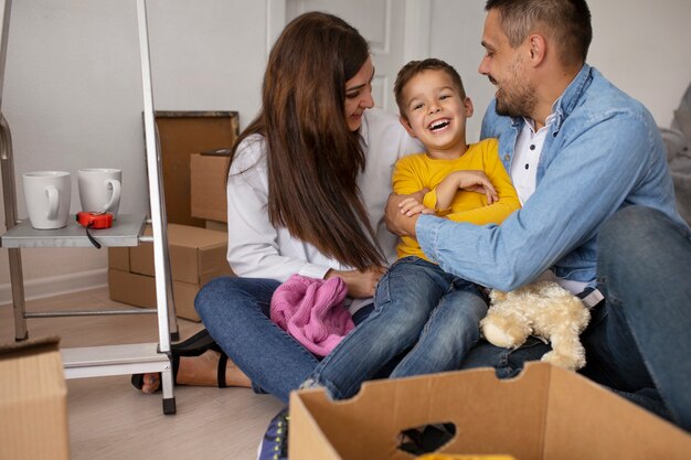 Full shot family ready to move into a new home