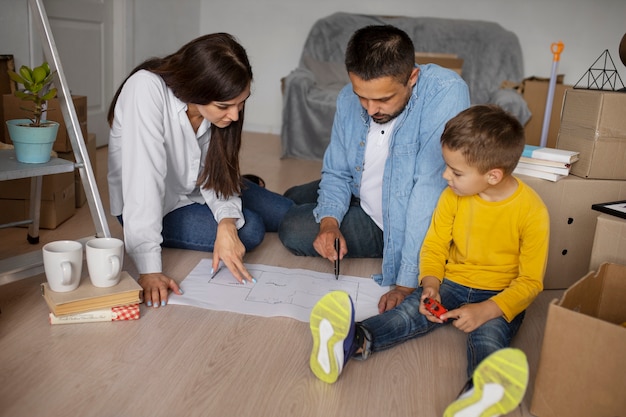 Full shot family ready to move into a new home