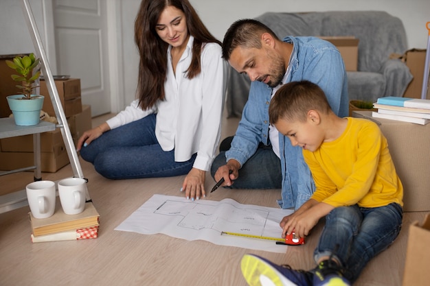 Full shot family ready to move into a new home